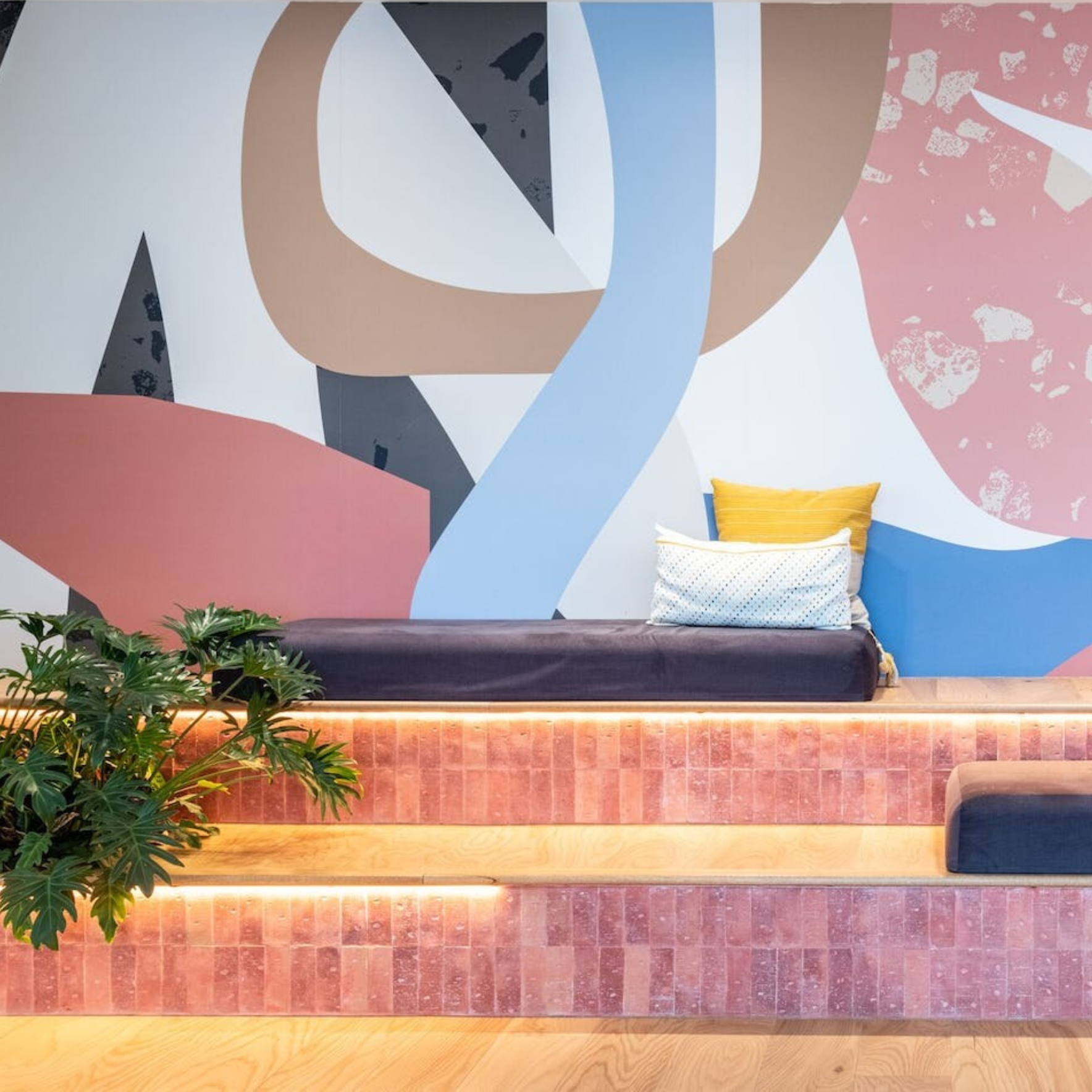 Photo of our office space with pink tiled stairs for collaboration and connection to take place.