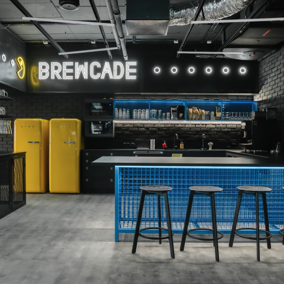 Photo of our office bar, with beer taps and bright yellow fridges.