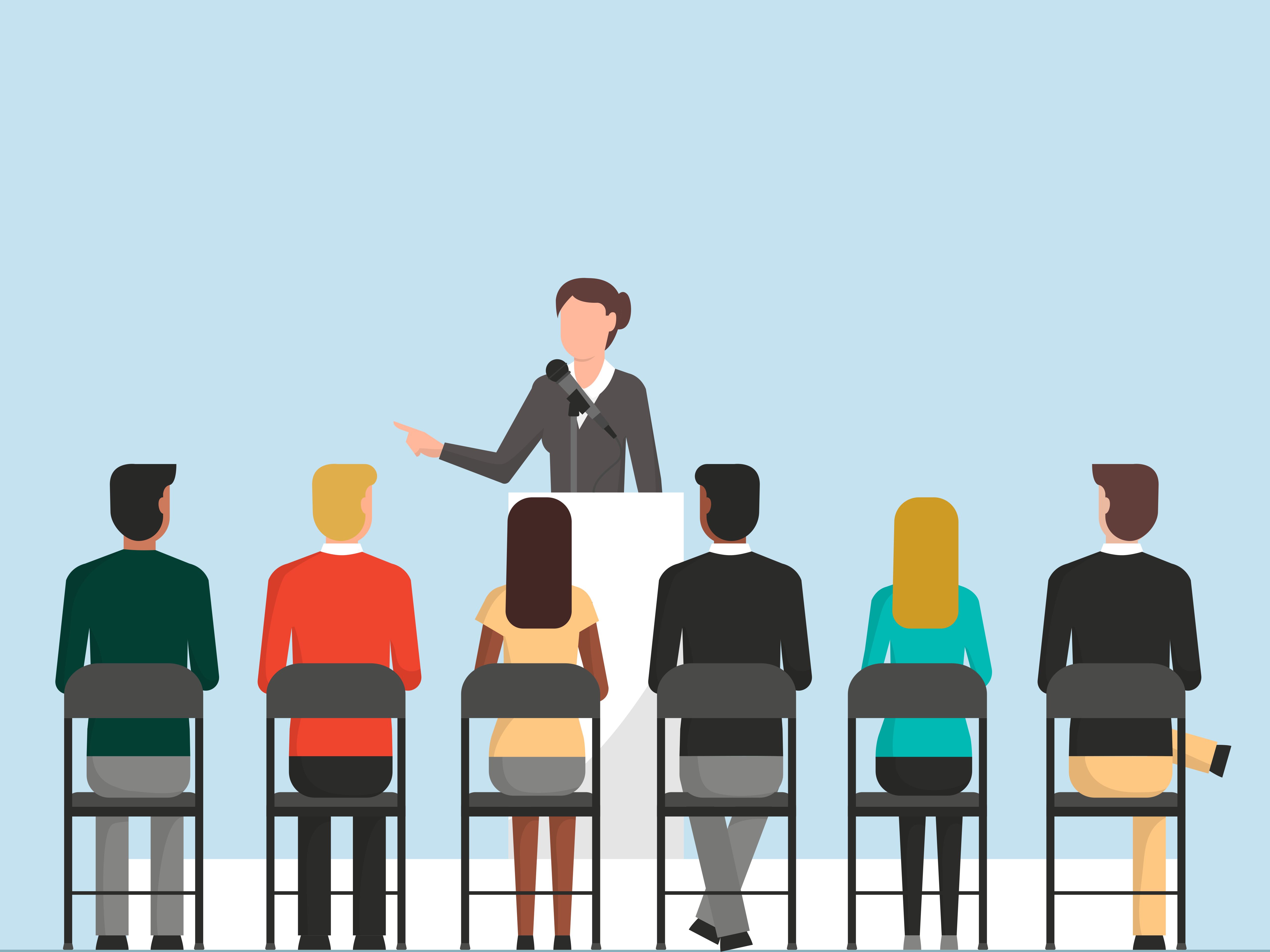 Women at podium speaking to a crowd