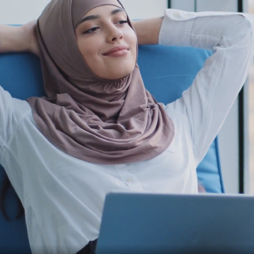 Girl working on computer relaxed and smiling.