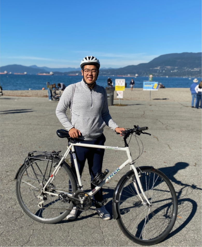 Tommy Xu standing with bike