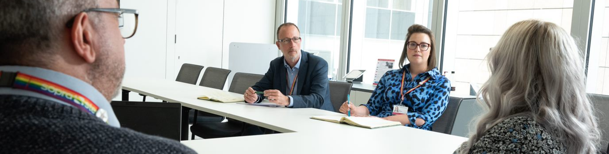 Four people having a meeting