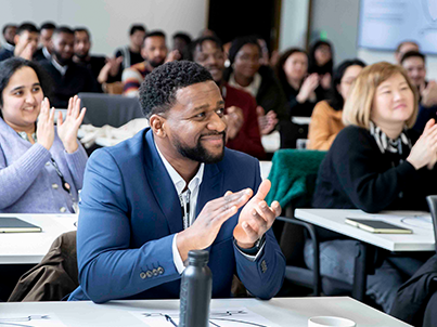 A room of colleagues clapping