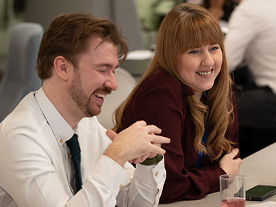 Colleagues smiling and listening to each other