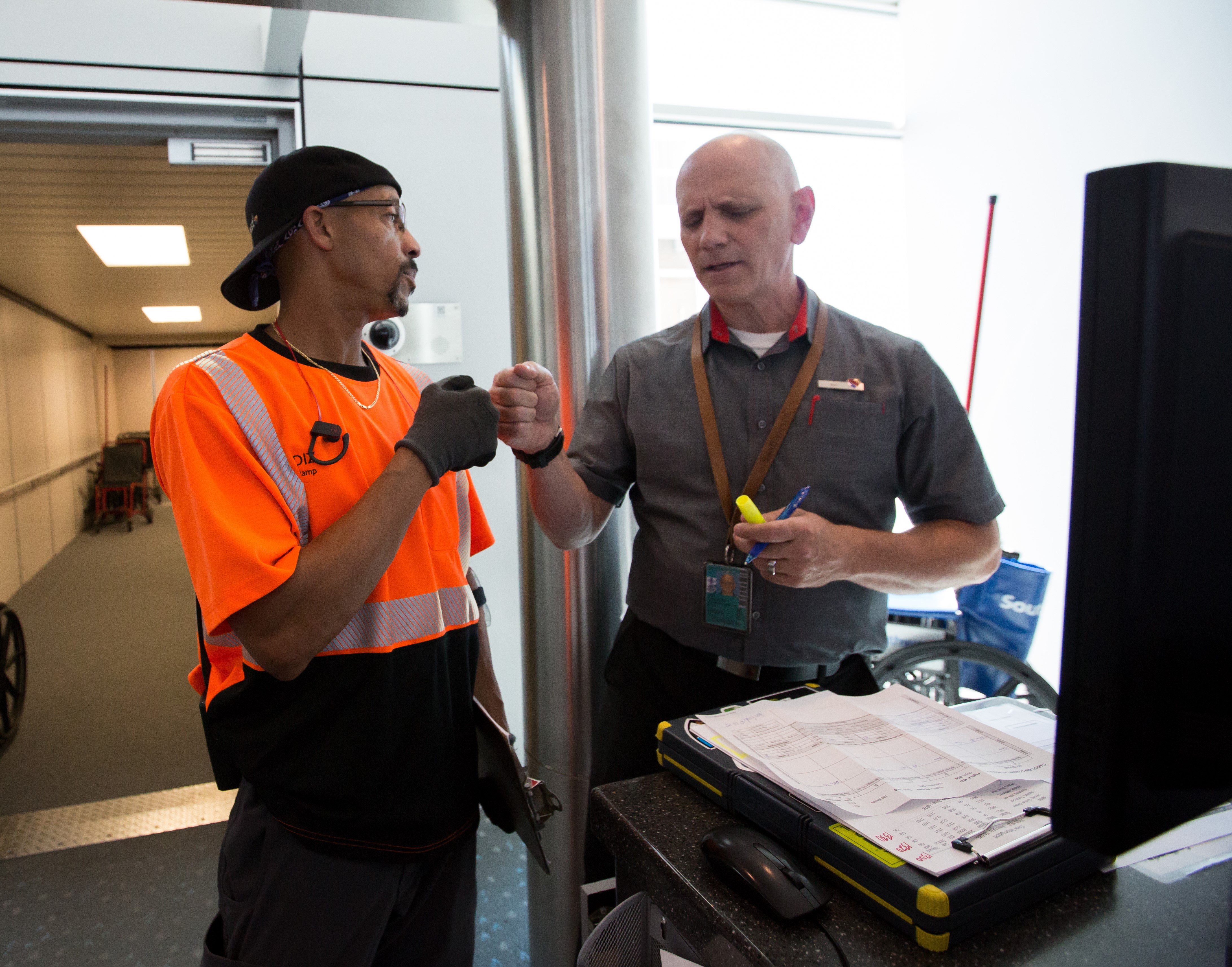 Operations Agent fist bumping.