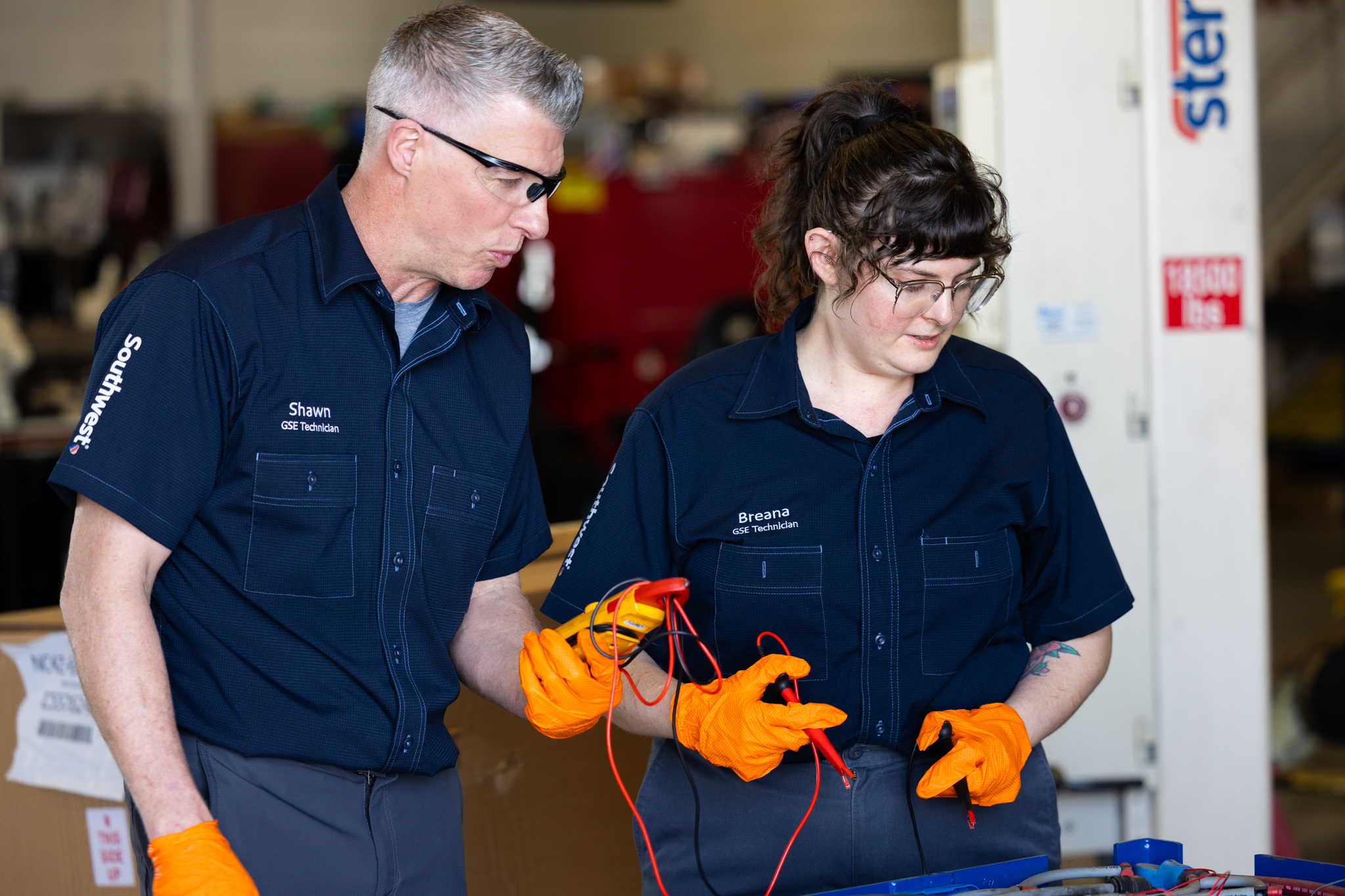 GSE Technicians in gloves working on an engine.