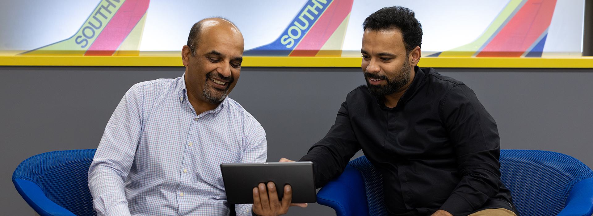 Two Employees holding a tablet