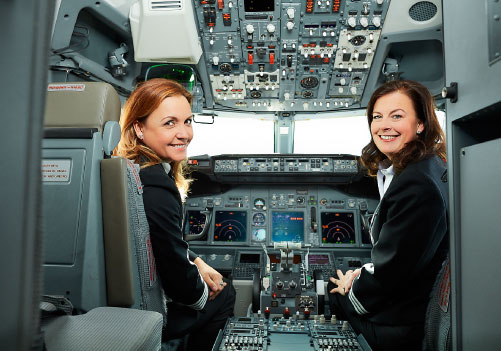 Image of female ramp agent stacking bags inside the belly of an airplane.