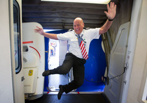 Image of two ramp agents laughing in a cargo bin.