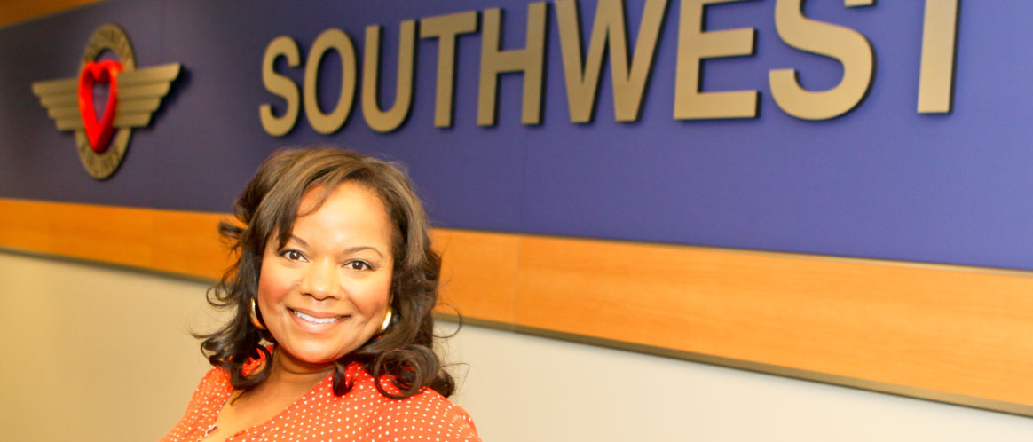 Roz smiling in front of a Southwest sign