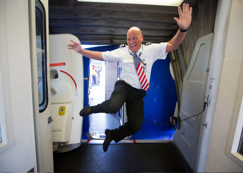 Six employees wrapping their arms around each other