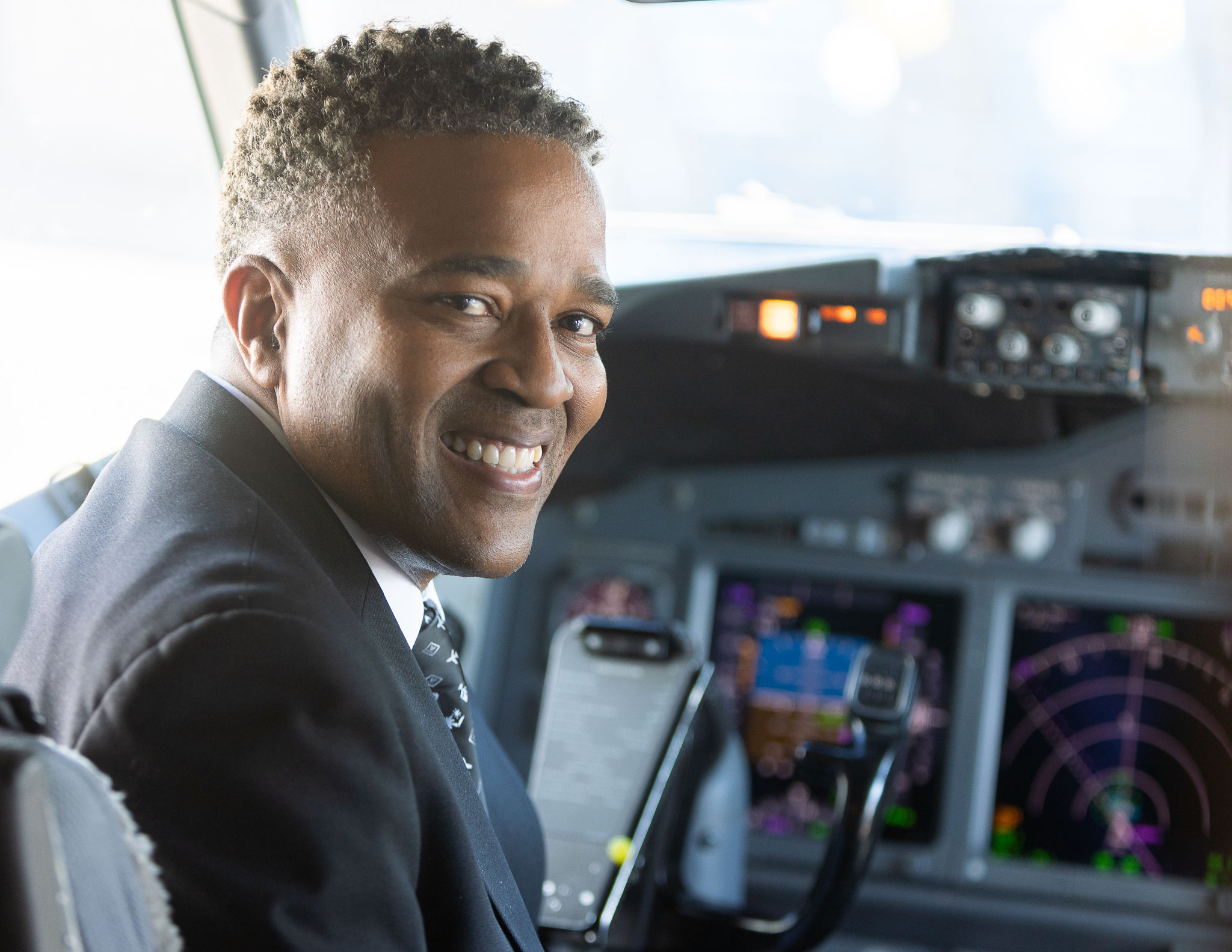 Photo of Captain Geoff B. smiling from the flight deck