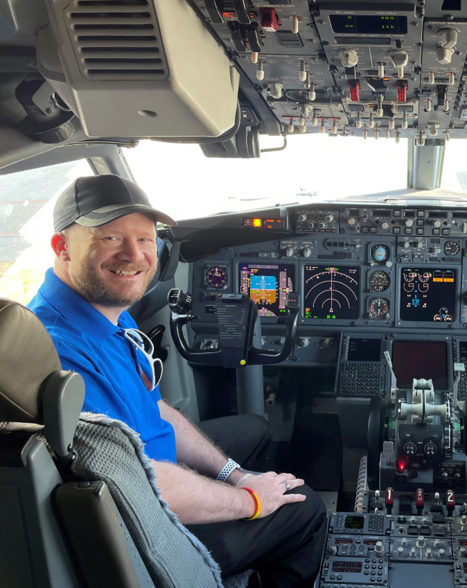 Matthew A. smiling in a Southwest flight deck