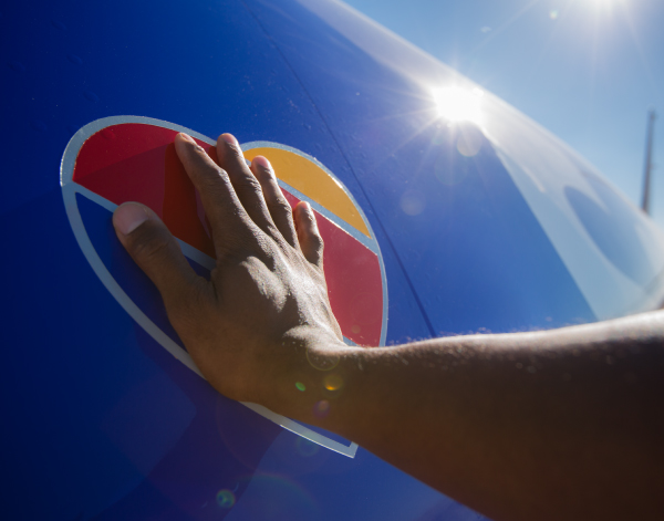 Southwest employee putting his hand over a Southwest heart