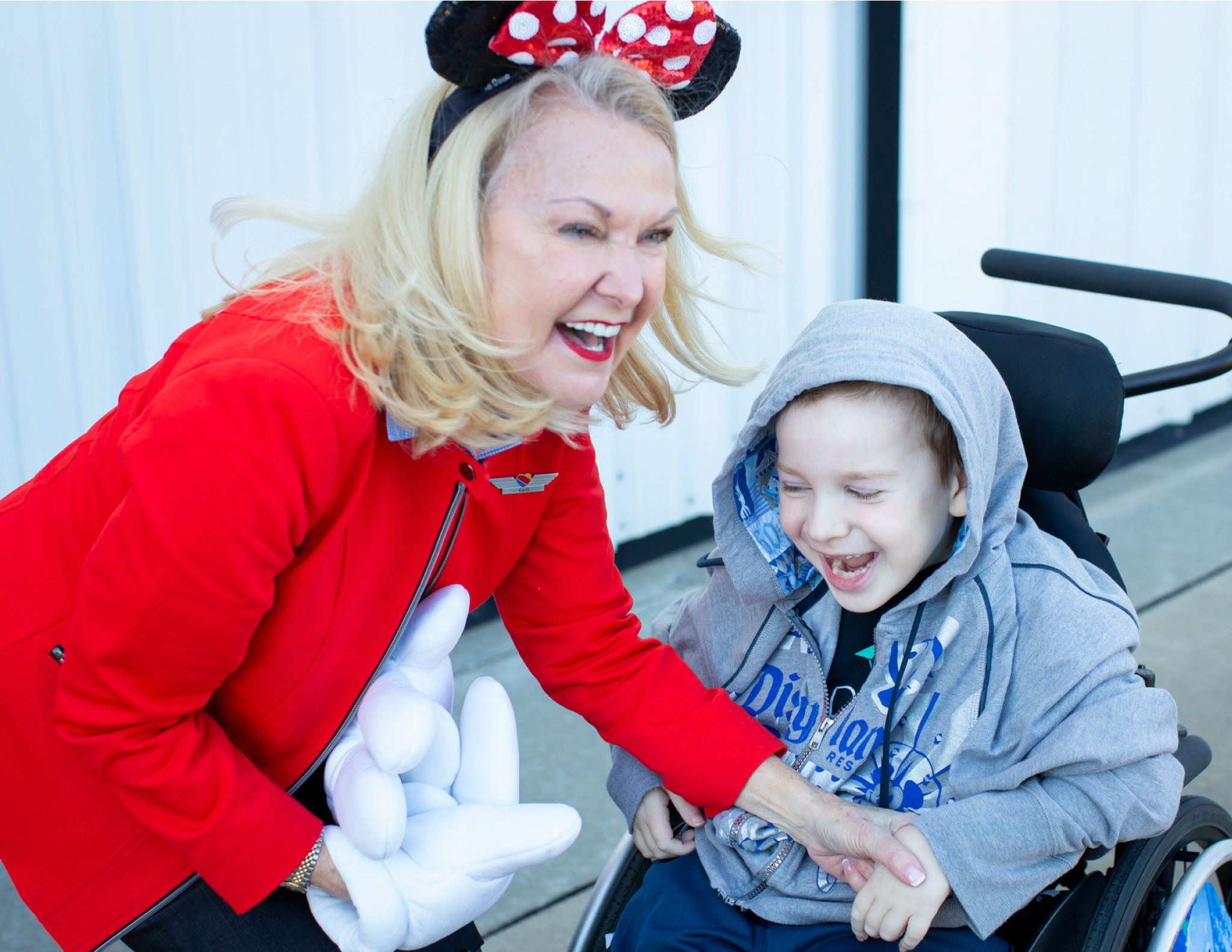 A Flight Attendant smiling with a young boy