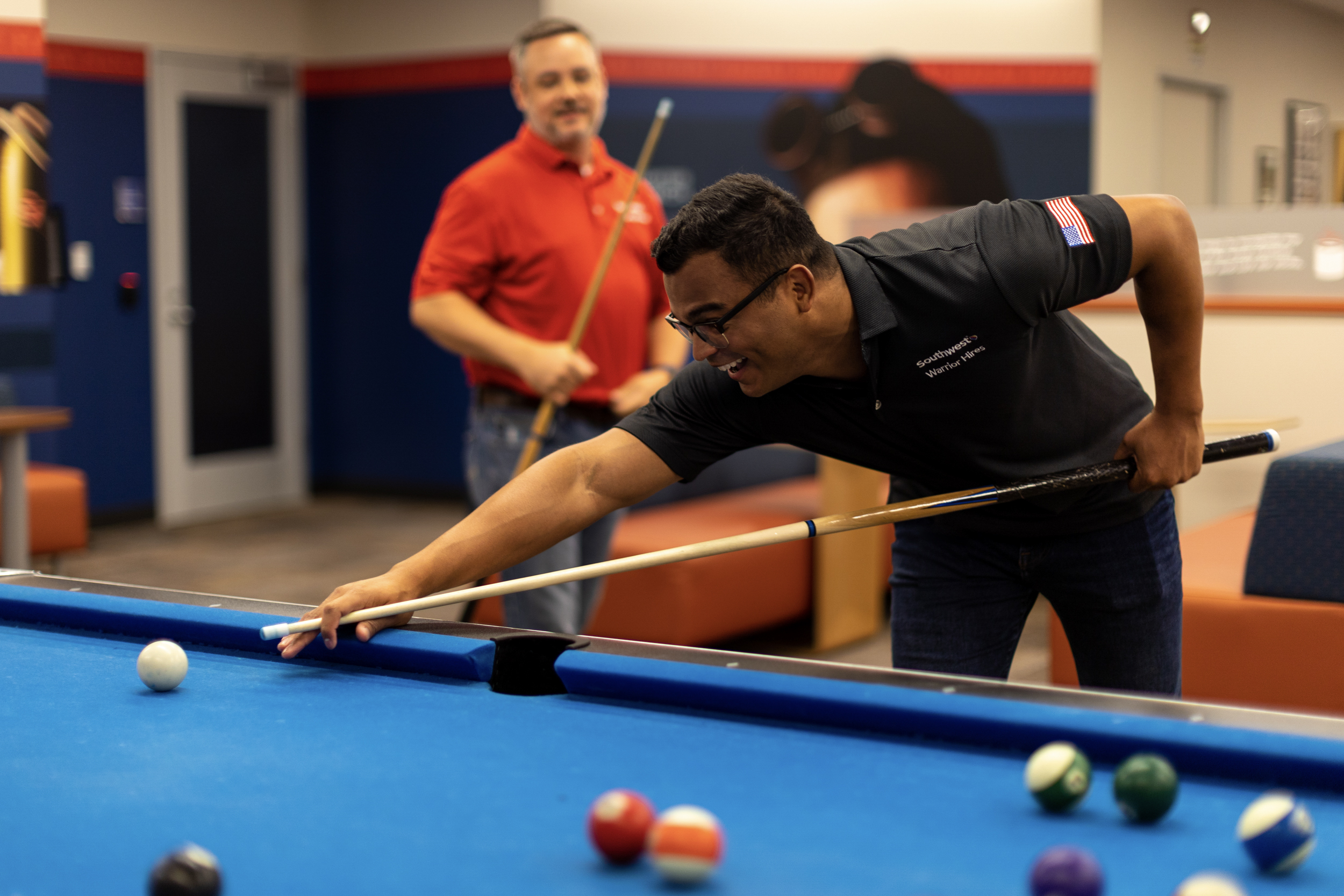 Two men playing pool at Southwest Headquarters