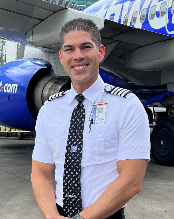 Captain Pablo O smiling outside of a Southwest 737