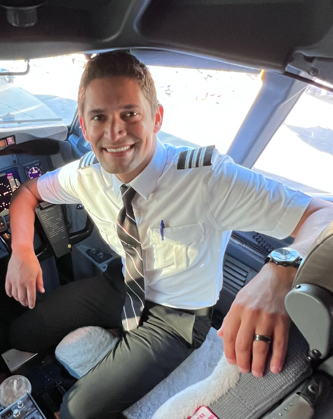 First Officer Tanner M. smiling in the flight deck