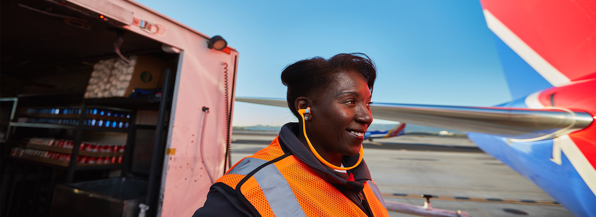 Provo Agent smiling while loading the plane full of sodas