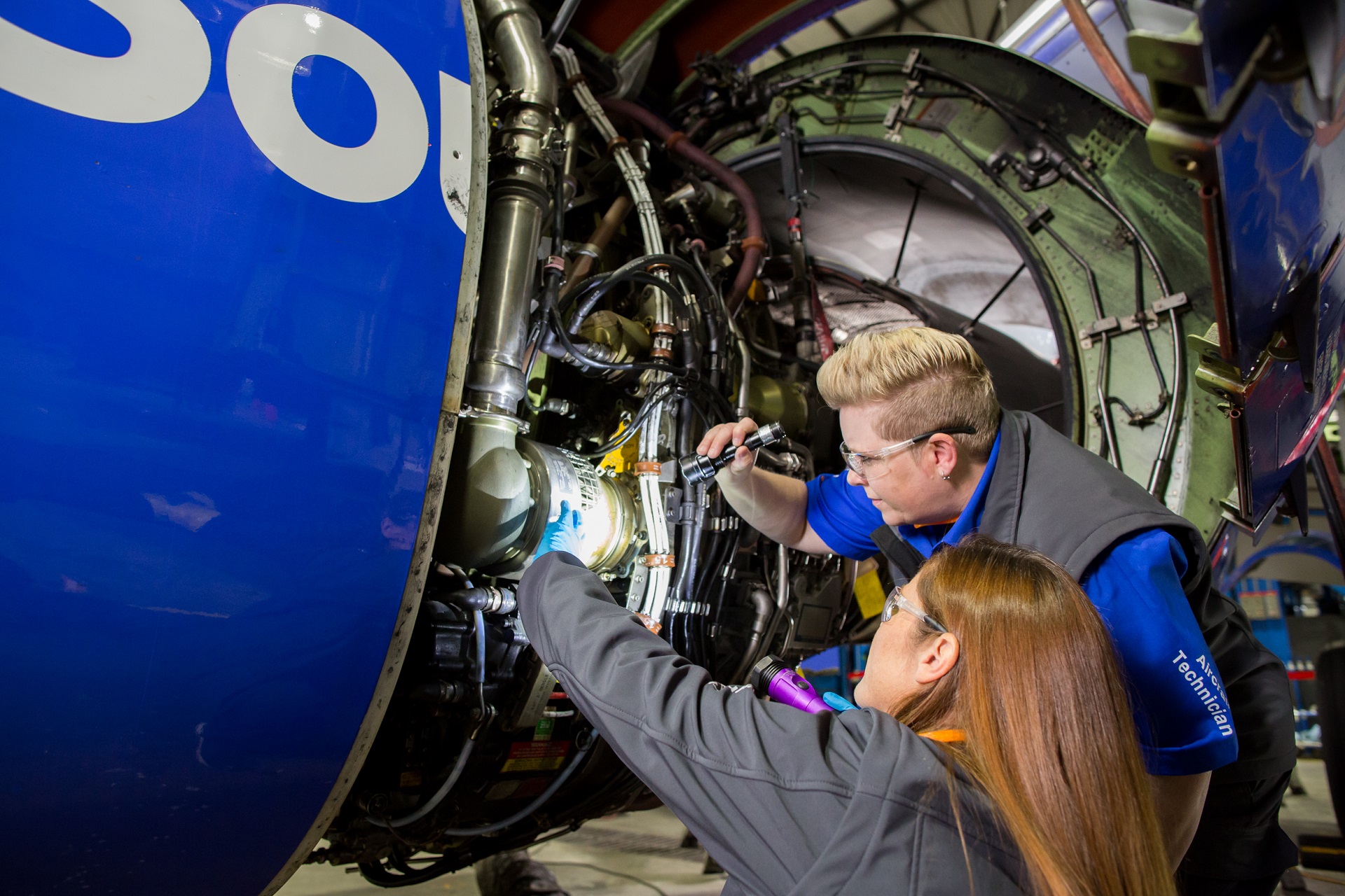 Two female Quality Control Inspectors checking out an aircraft