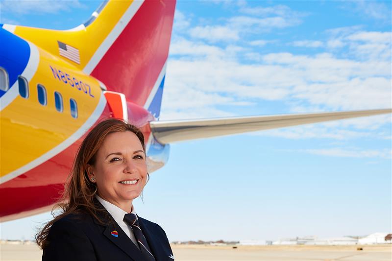Southwest Airlines First Officer smiling outside of the window of the flight deck