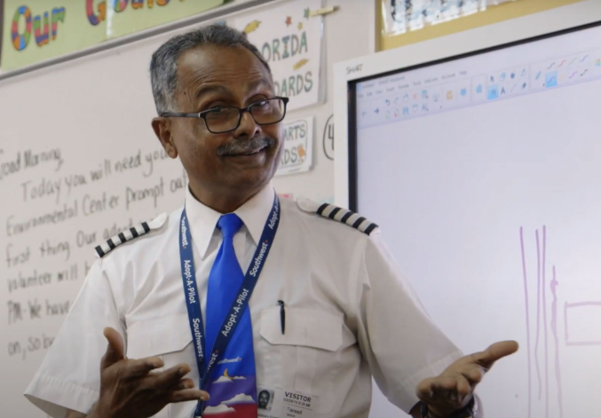 Photo of Captain Atif F. speaking in a classroom to students