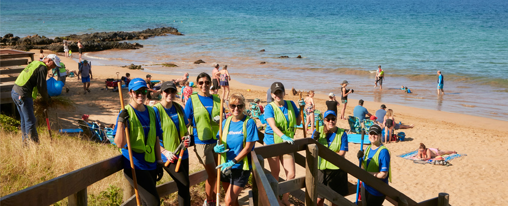 Photo of Employees volunteering at a beach cleanup in Maui