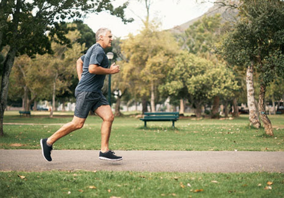 Man jogging past park bench