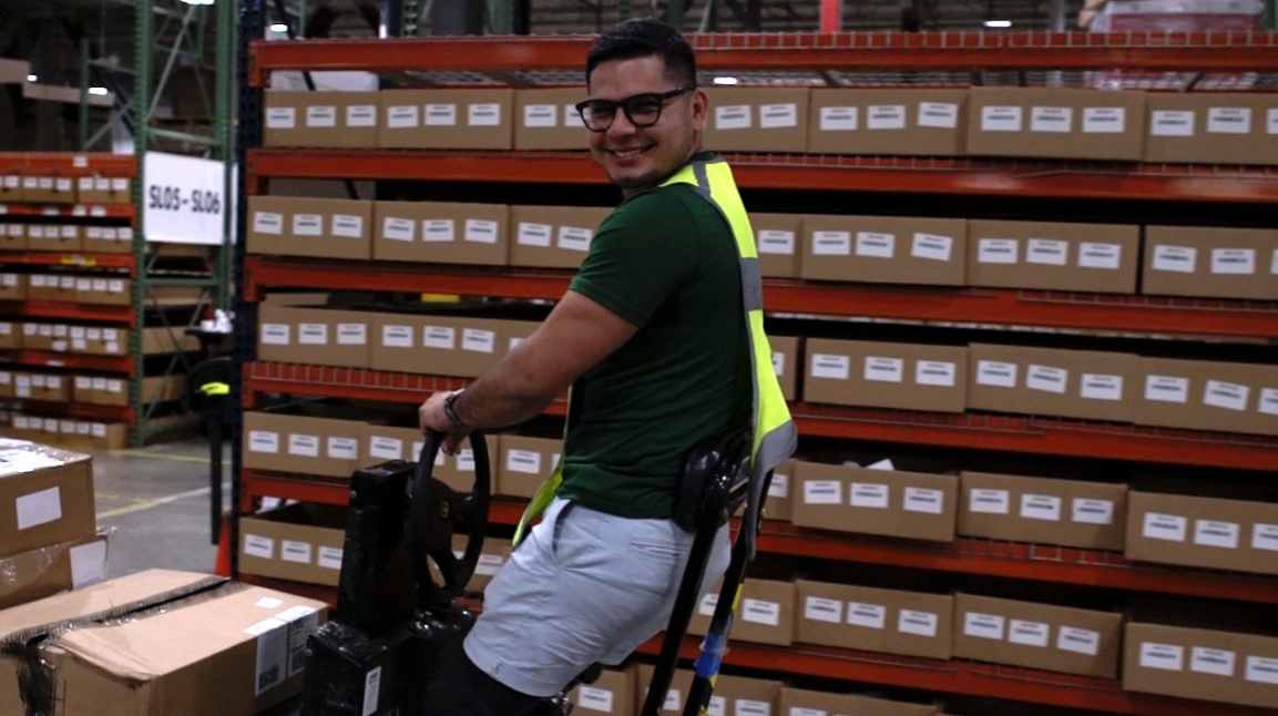 Edel Gray Ulloa smiling and working at BSN SPORTS warehouse facility.