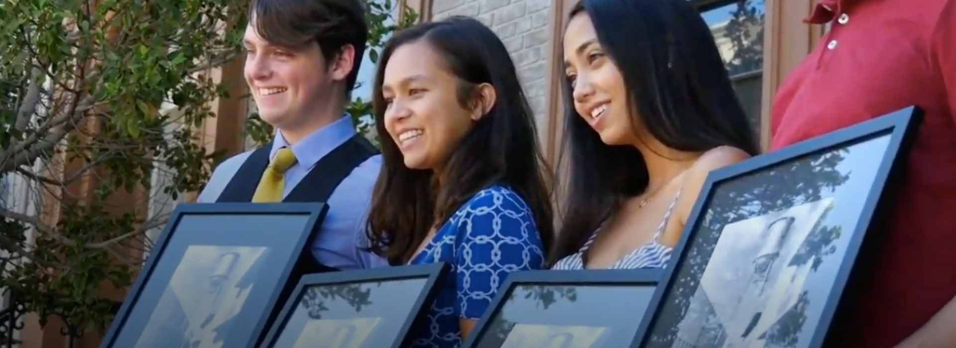 Group of Reach Honorship students receiving framed photo of WB water tower